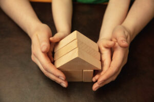 collecting-wooden-constructor-like-house-close-up-shot-female-kid-s-hands-doing-different-things-together-family-home-education-childhood-charity-concept-mother-son-daughter